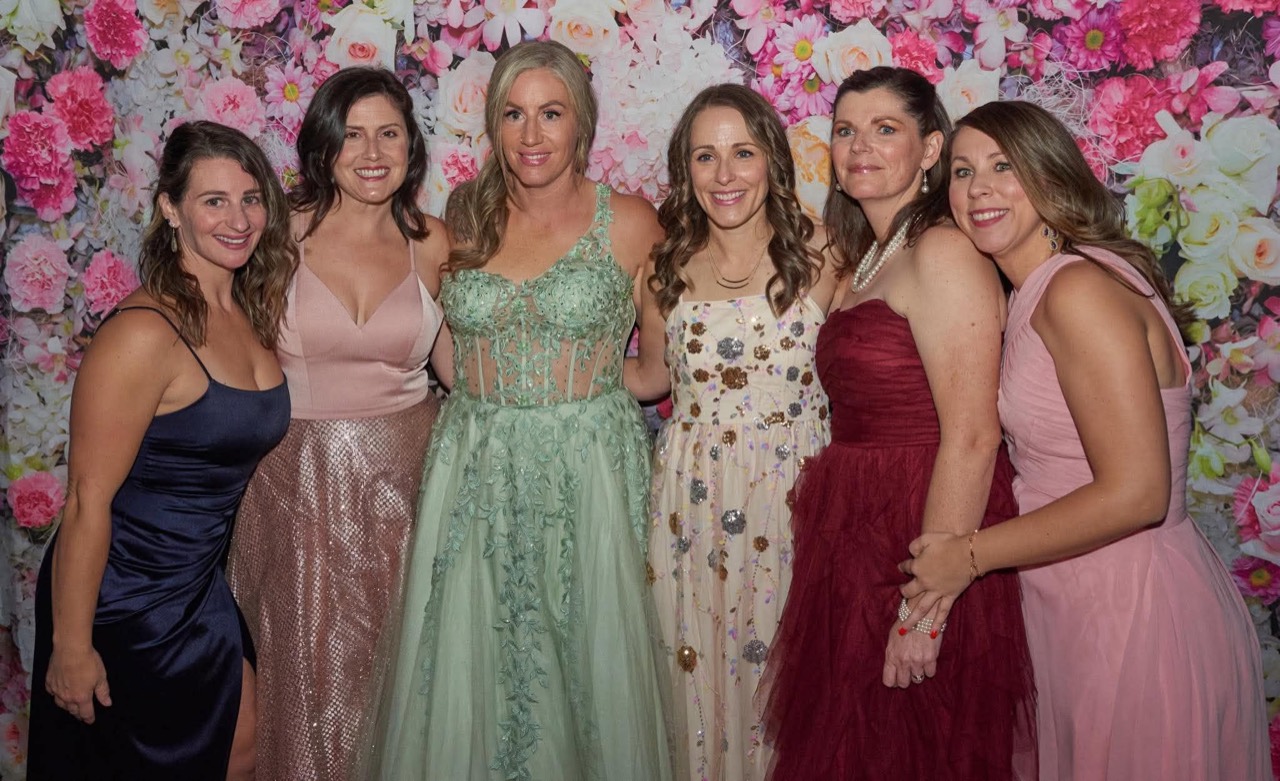 Guests dressed in elegant gowns at a past Parent Prom